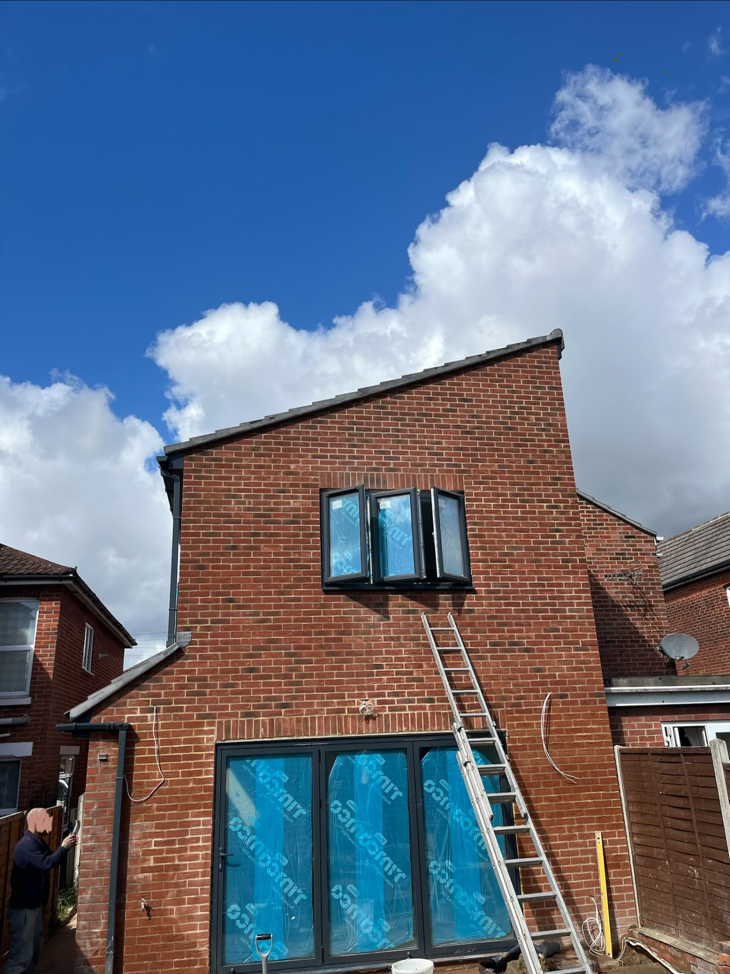 Completed rebuilt rear exterior with new brickwork and bifold doors by BMS