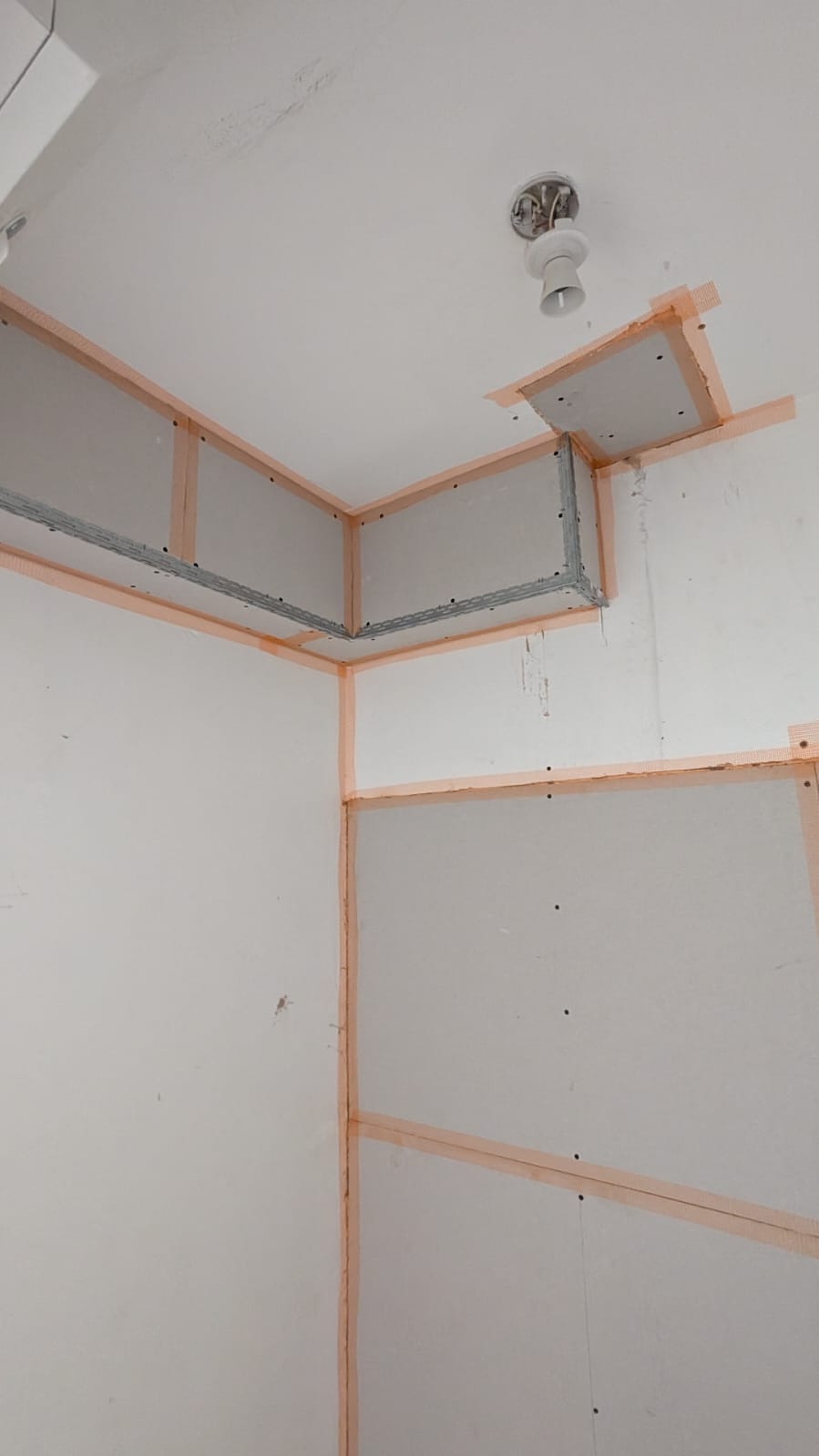 Plasterboard preparation and joint detailing before final finishing by BMS
