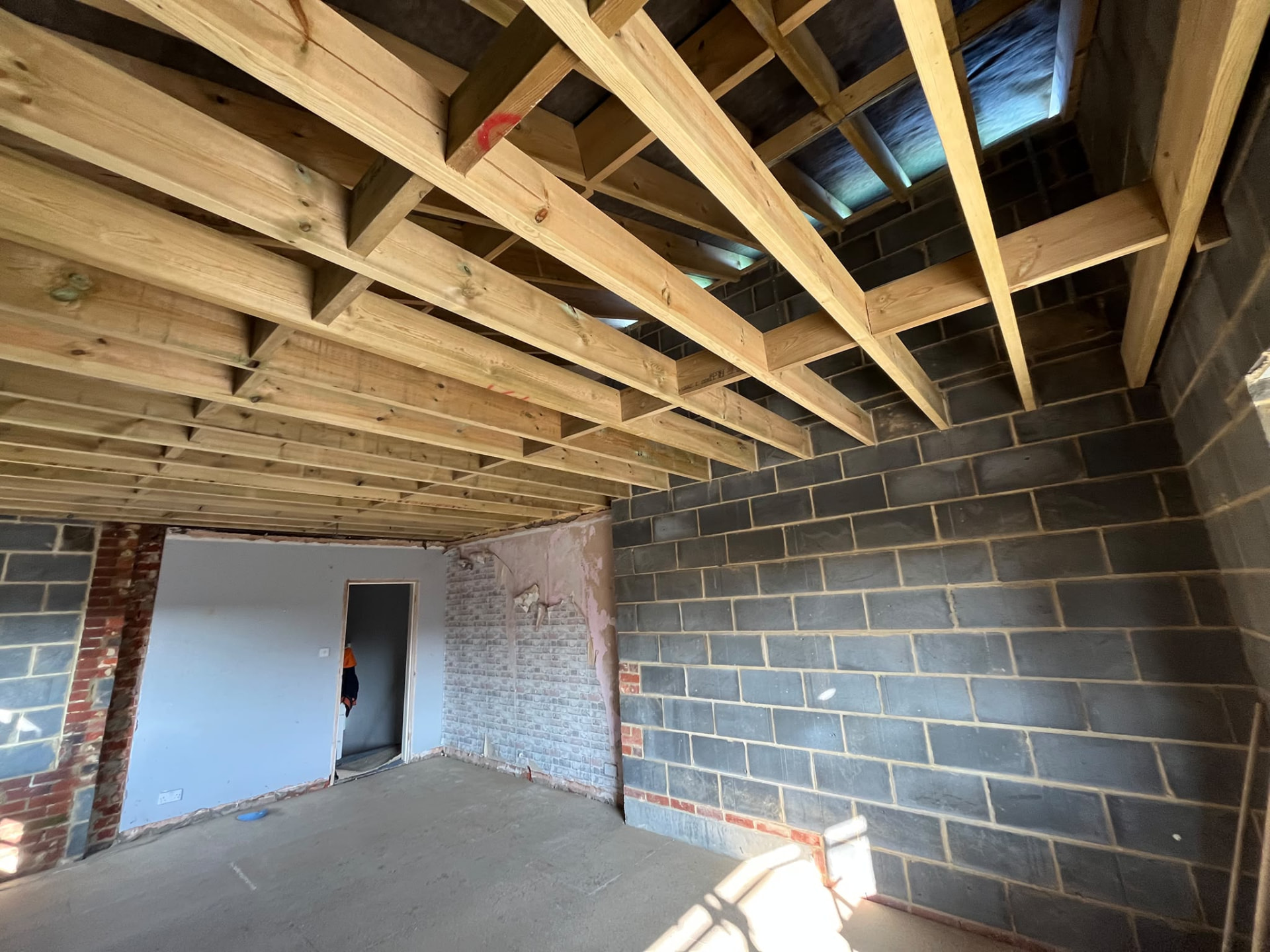 New blockwork walls and timber ceiling joists during a BMS rebuild
