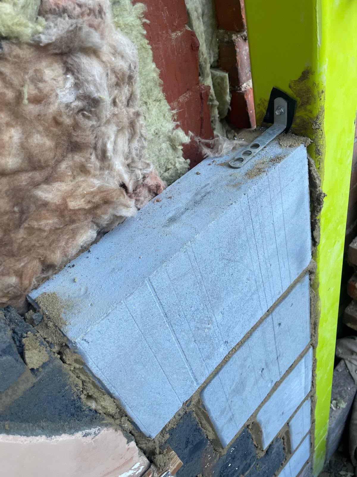 Structural steel connection integrated into existing masonry during a BMS building project