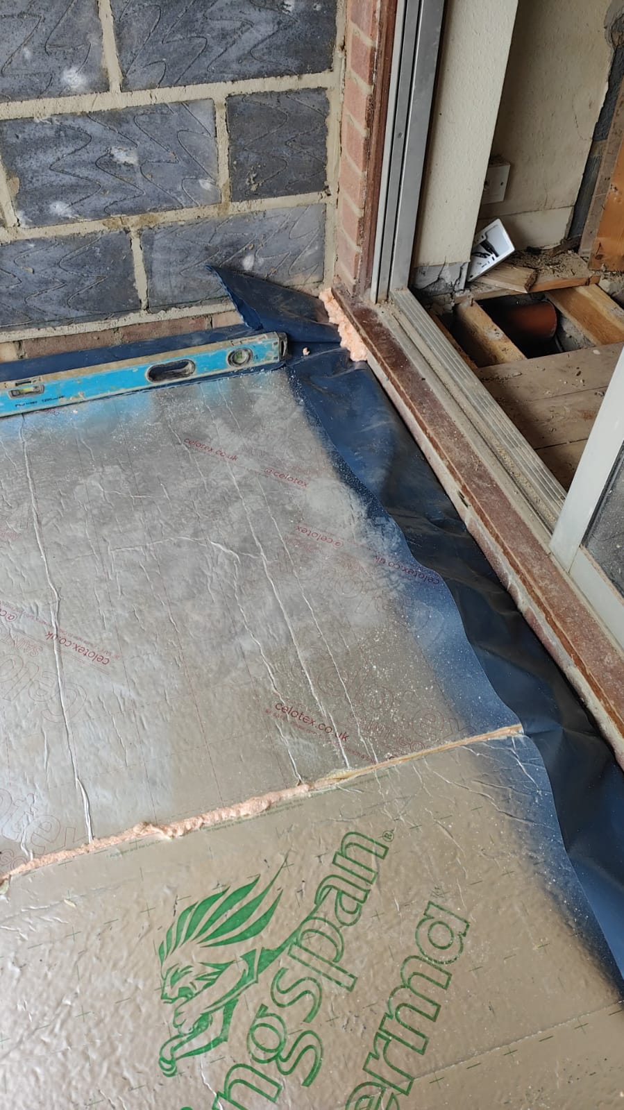 Floor insulation boards laid over a membrane during a BMS residential building project